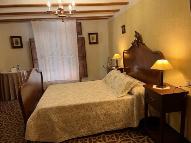Bedroom with wooden headboard and warm bedside lamps